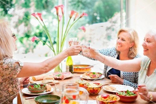 Women making a toast at the dinenr table